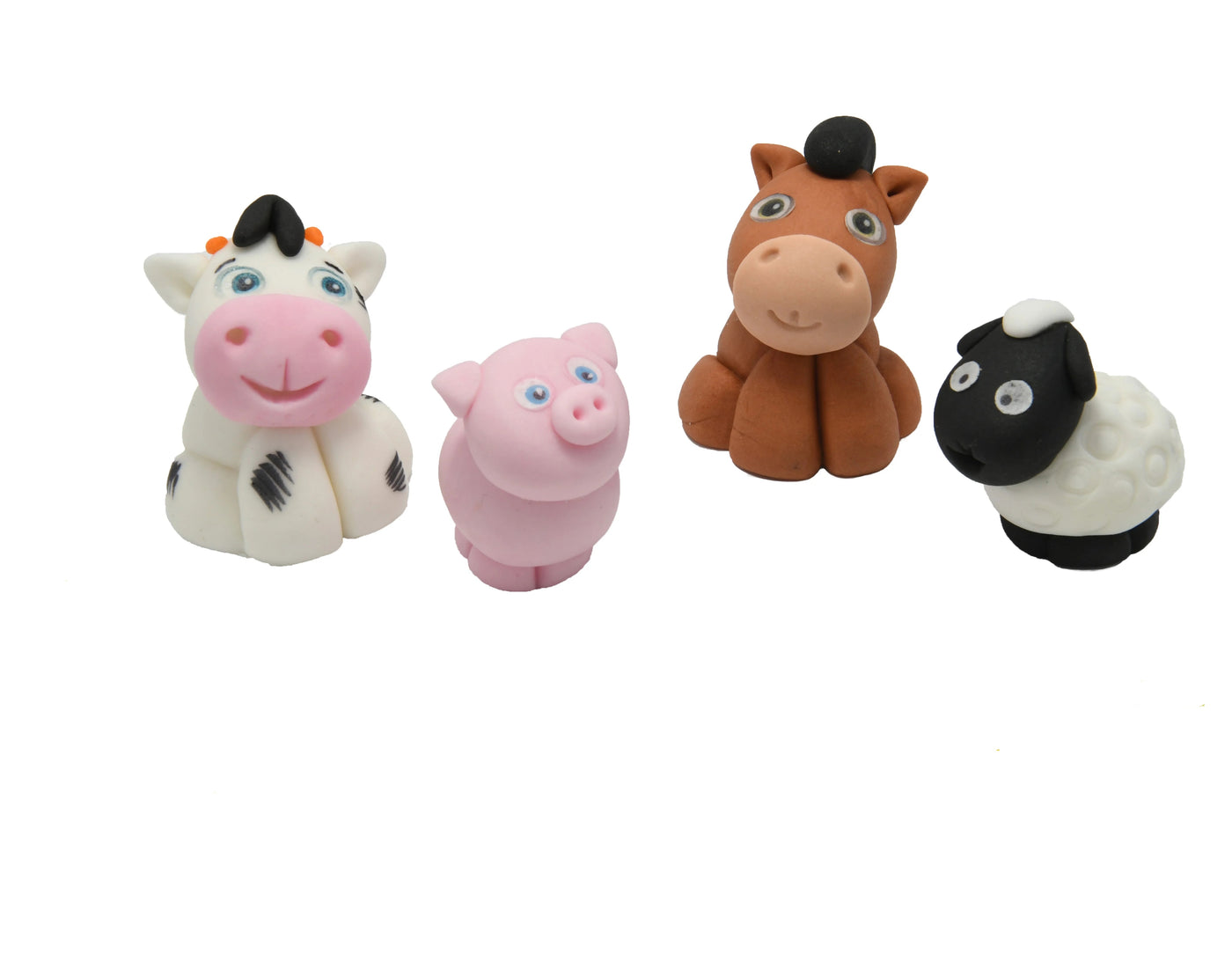 Ätbar dekoration gjord i sockerpasta, föreställande en häst, en ko, ett får och en gris