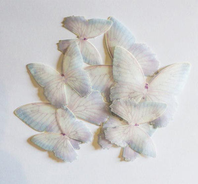 Ätbara fjärilar av waferpaper, i lila och vitt