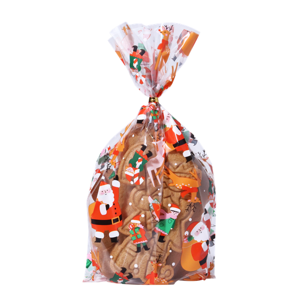 Transparenta julpåsar fyllda med kakor och godis, dekorerade med tomtemotiv