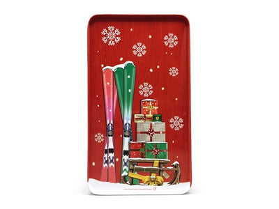 Baksida av röd plåtburk med skidor och staplade julklappar på snöig bakgrund